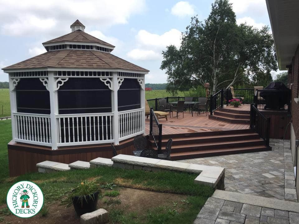 Multi-level deck with a large white screened gazebo.