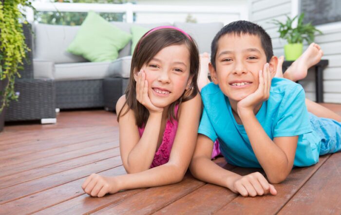Smiling children laying on deck