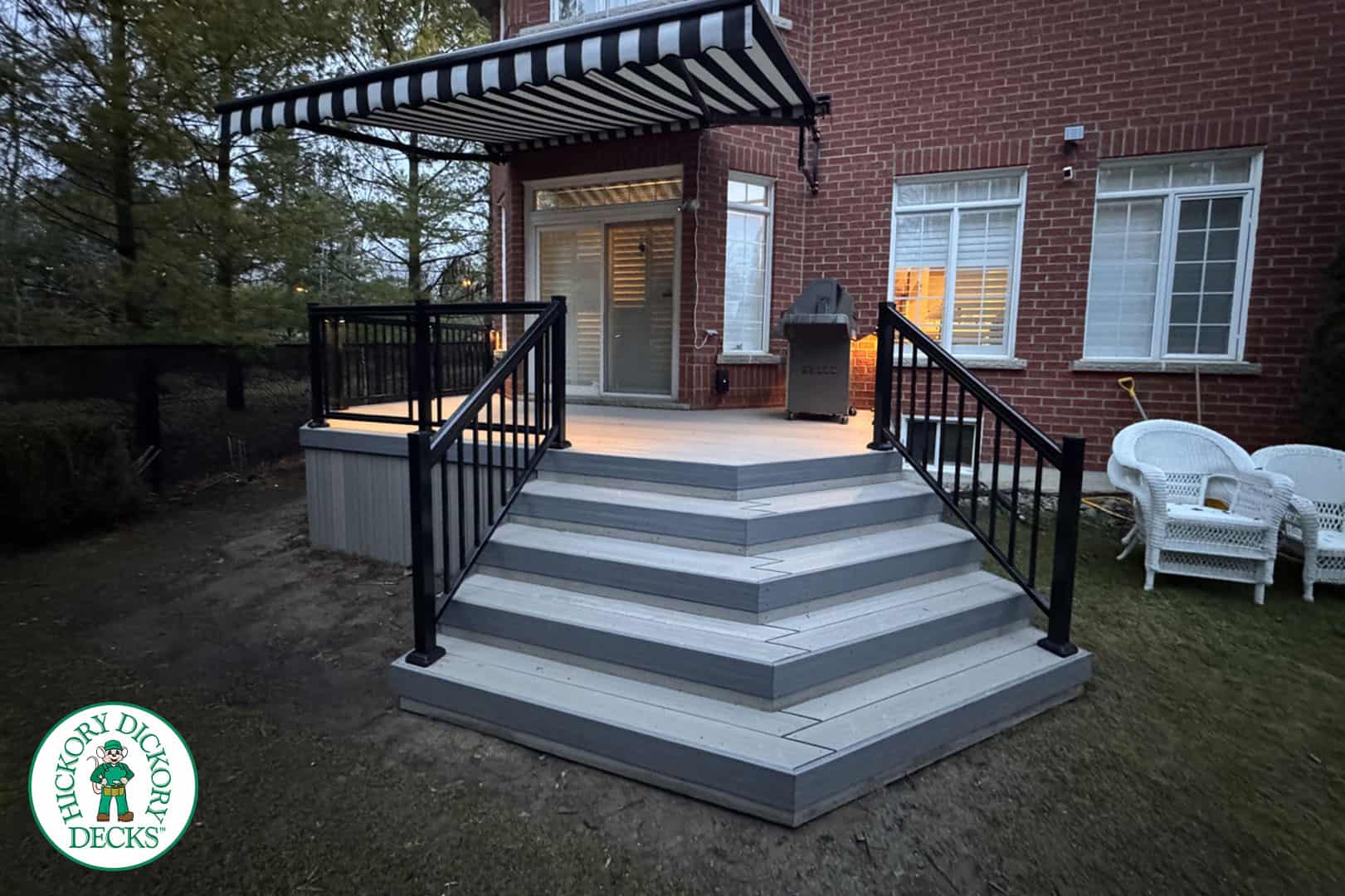 HDD_Awning_Watermarked Backyard deck with striped awning.