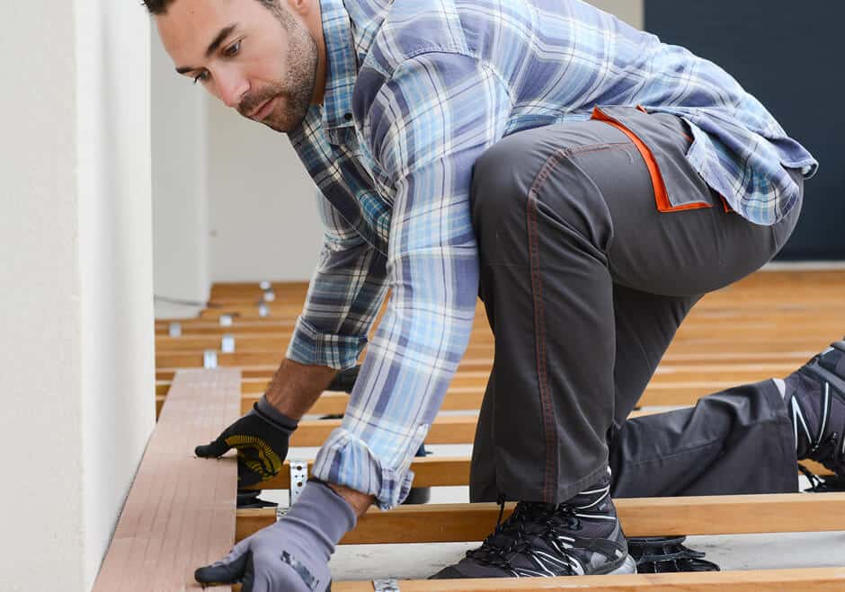 deck contractor laying down deck board