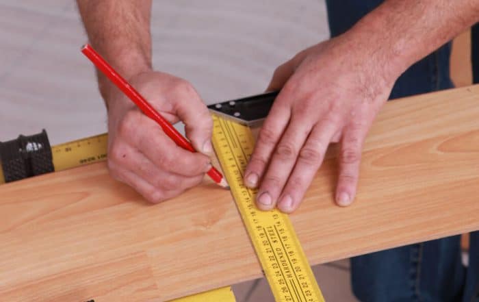 marking a deck board with pencil