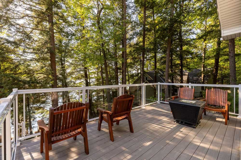 Muskoka forest and lake view with modern glass railings