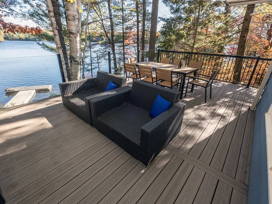 outdoor furniture on composite deck overlooking a lake in Muskoka